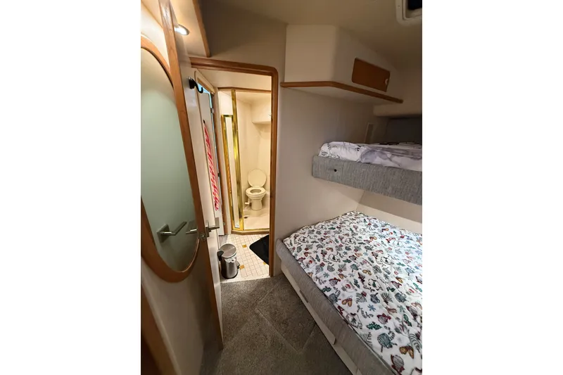 Slide: The Image of Interior of 1994 Sea Ray 500 Sundancer with bunk beds and bathroom. - 35