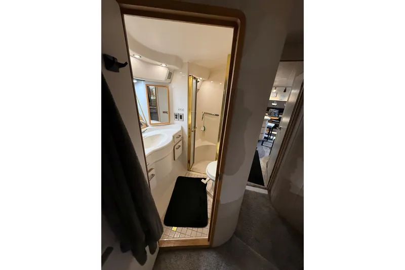 Slide: The Image of Bathroom interior of 1994 Sea Ray 500 Sundancer yacht, featuring sink and shower. - 45