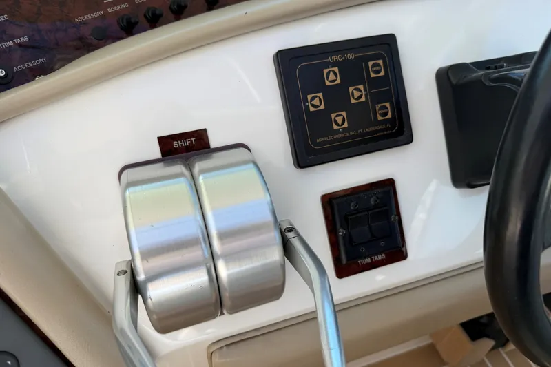 Slide: The Image of Control panel of a 1994 Sea Ray 500 Sundancer boat with shift levers and buttons. - 21