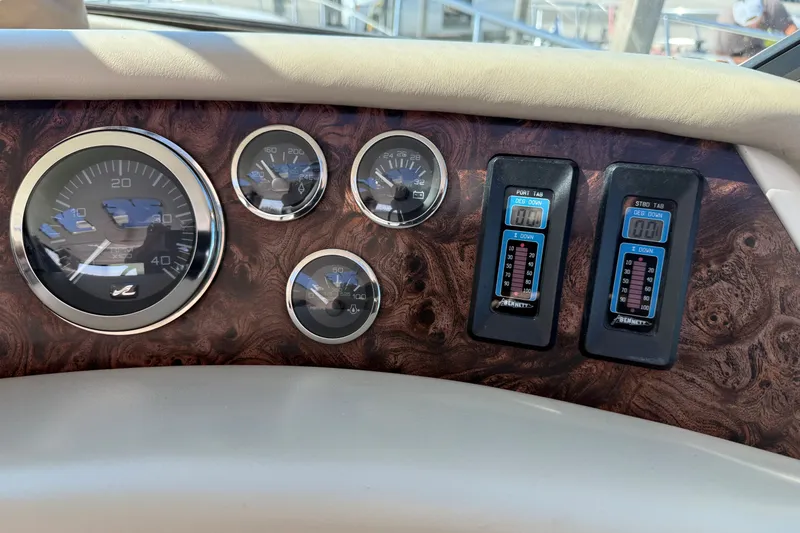 Slide: The Image of Dashboard of a 1994 Sea Ray 500 Sundancer with gauges and controls. - 19