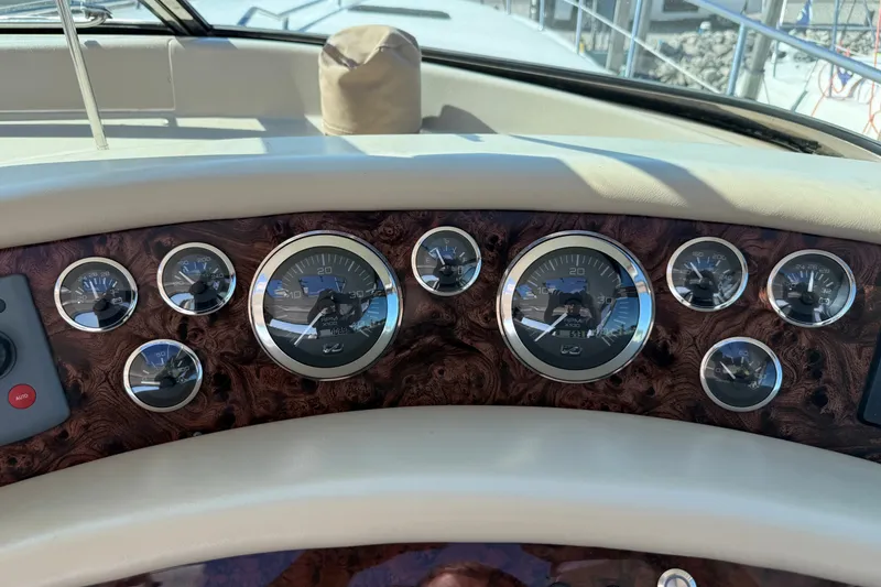 Slide: The Image of Dashboard of a 1994 Sea Ray 500 Sundancer boat with multiple gauges and wood finish. - 18