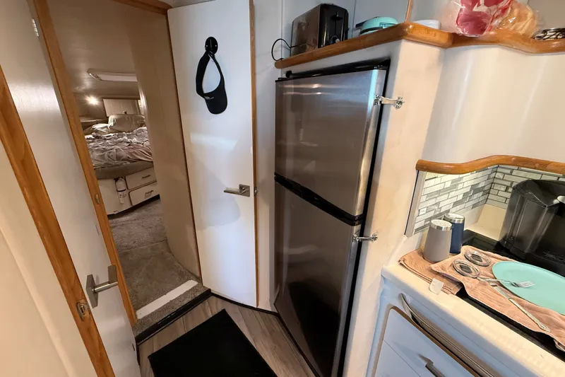 Slide: The Image of Interior of 1994 Sea Ray 500 Sundancer yacht with kitchen and bedroom view. - 39