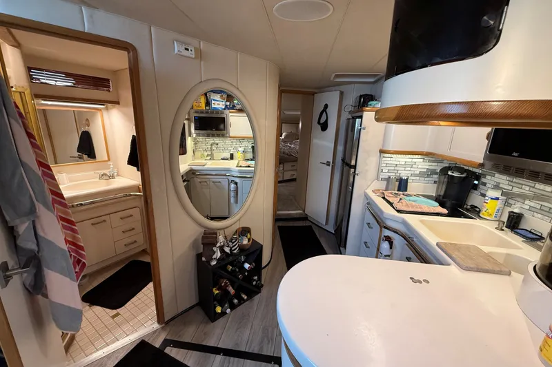 Slide: The Image of Interior of 1994 Sea Ray 500 Sundancer yacht, featuring kitchen and bathroom areas. - 32