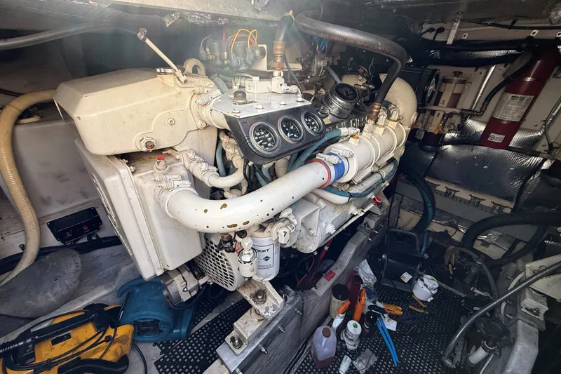Slide: The Image of Engine room of a 1994 Sea Ray 500 Sundancer with visible gauges and tools. - 55