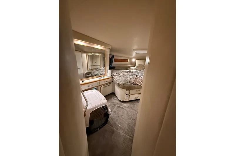 Slide: The Image of Cozy cabin interior of 1994 Sea Ray 500 Sundancer yacht with bed and mirrored vanity. - 41