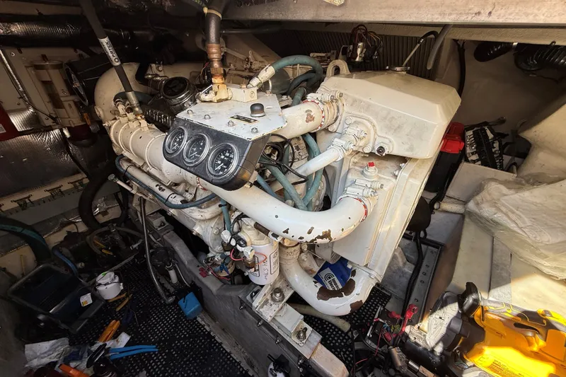 Slide: The Image of Engine room of a 1994 Sea Ray 500 Sundancer with visible gauges and components. - 52
