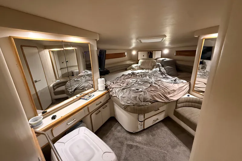 Slide: The Image of Luxurious cabin interior of a 1994 Sea Ray 500 Sundancer yacht with cozy bedding. - 42