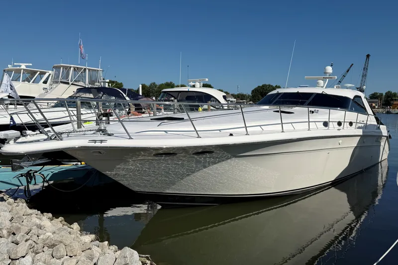 The Image of 1994 Sea Ray 500 Sundancer yacht docked at marina under clear blue sky. - 0