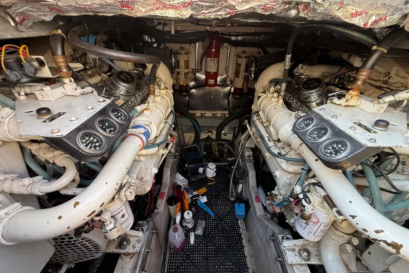 Slide: The Image of Engine room of a 1994 Sea Ray 500 Sundancer with dual engines and gauges. - 51