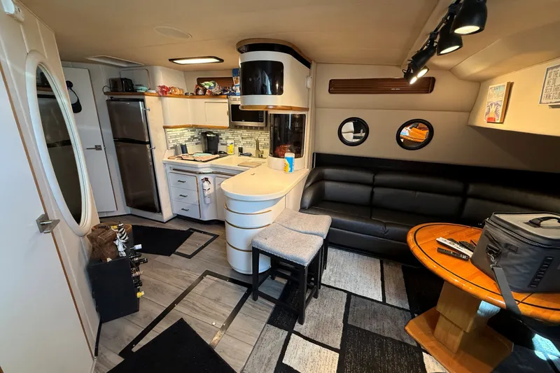 Slide: The Image of Interior of 1994 Sea Ray 500 Sundancer yacht with modern kitchen and seating area. - 28