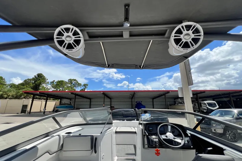Slide: The Image of 2022 Yamaha Boats AR190 interior with speakers and steering wheel under a canopy. - 26