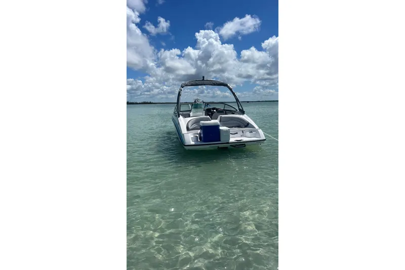 Slide: The Image of 2022 Yamaha AR190 boat anchored in clear turquoise water under a partly cloudy sky. - 4