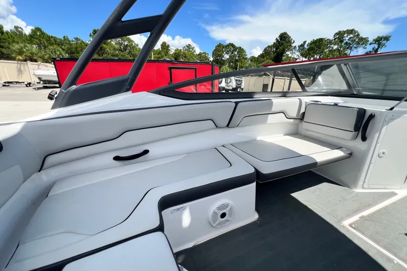 Slide: The Image of 2022 Yamaha Boats AR190 interior with sleek white seating and modern design. - 24