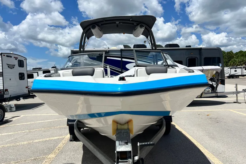 Slide: The Image of 2022 Yamaha Boats AR190 on trailer, parked outdoors under a partly cloudy sky. - 9