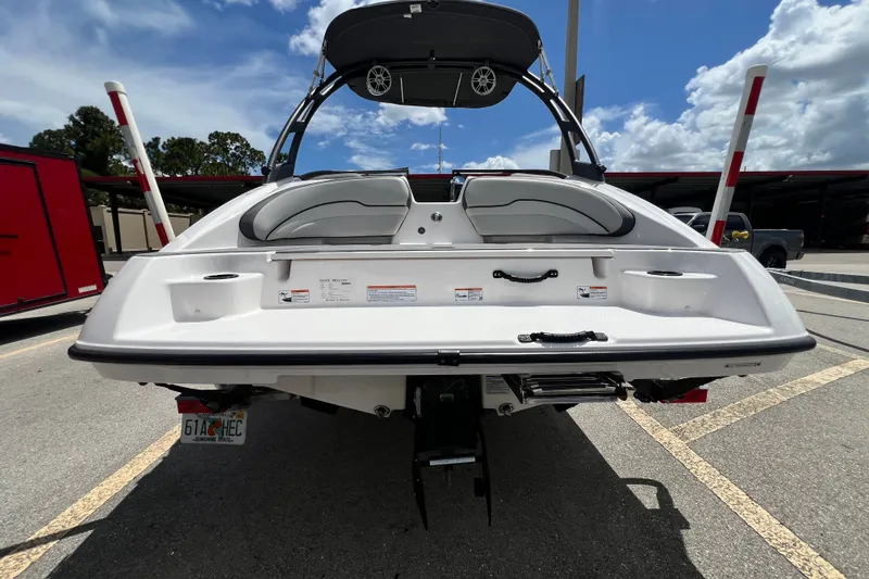 Slide: The Image of 2022 Yamaha Boats AR190 rear view in parking lot under blue sky. - 3