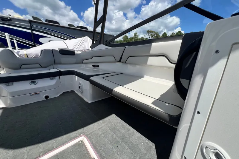 Slide: The Image of 2022 Yamaha Boats AR190 interior seating with sleek design under a blue sky. - 46