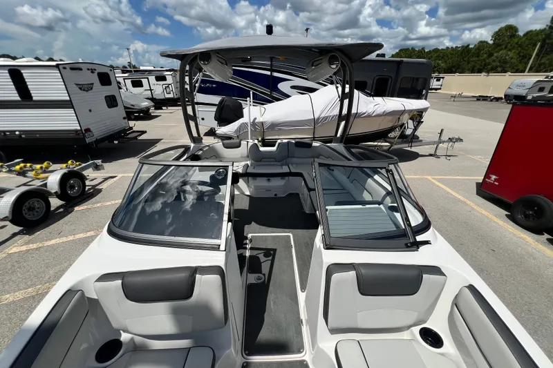 Slide: The Image of 2022 Yamaha Boats AR190 interior view at a dealership, showcasing seating and dashboard. - 43
