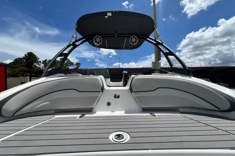 Slide: The Image of 2022 Yamaha Boats AR190 with sleek seating and canopy under a bright blue sky. - 15
