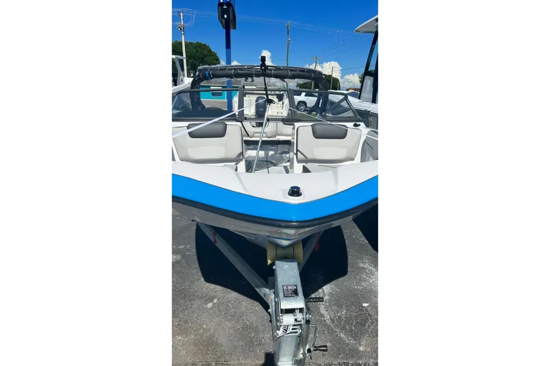 Slide: The Image of 2022 Yamaha Boats AR190, sleek design, parked on trailer, sunny day. - 2