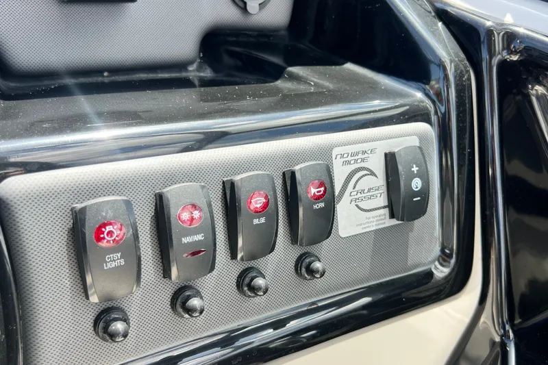 Slide: The Image of Control panel of a 2022 Yamaha Boats AR190, featuring various switches and buttons. - 38