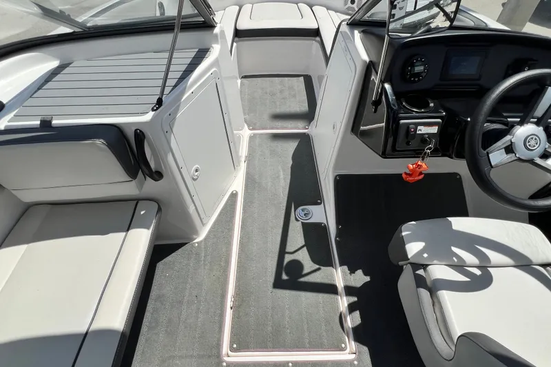 Slide: The Image of 2022 Yamaha Boats AR190 interior cockpit with steering wheel and seating. - 32