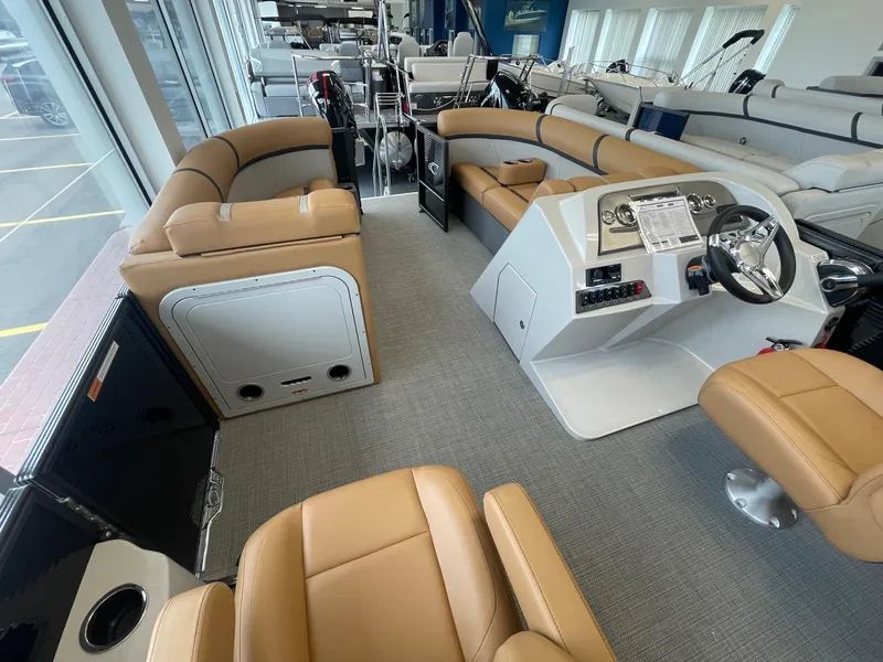 Slide: The Image of 2024 Crest 220SLC Classic LX boat interior with tan seating and modern helm. - 12