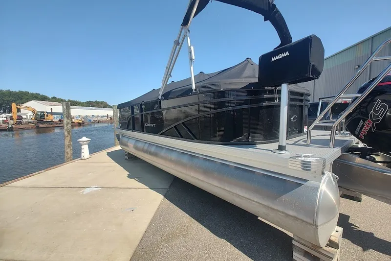 Slide: The Image of 2024 Crest 220SLC Classic LX pontoon boat docked by the water. - 3