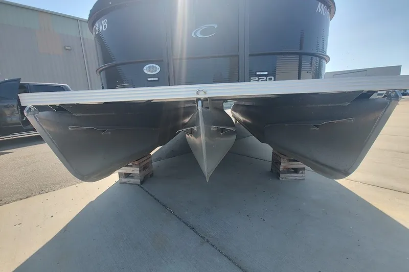 Slide: The Image of 2024 Crest 220SLC Classic LX pontoon boat on pallets, front view in sunlight. - 6
