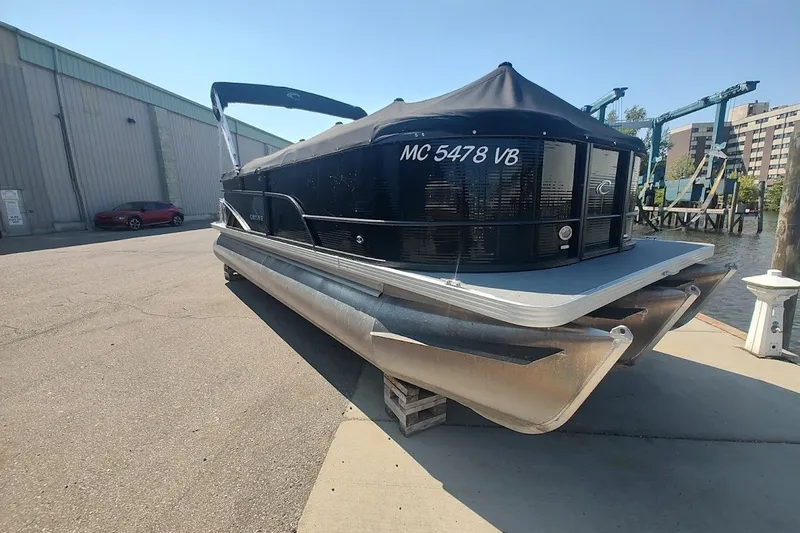 Slide: The Image of 2024 Crest 220SLC Classic LX pontoon boat docked on a sunny day. - 4