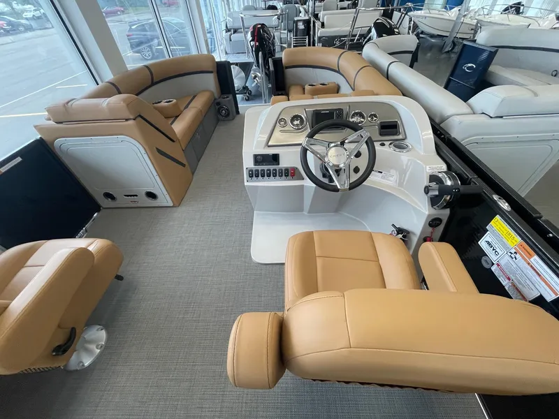Slide: The Image of 2024 Crest 220SLC Classic LX boat interior with tan seating and modern dashboard. - 13
