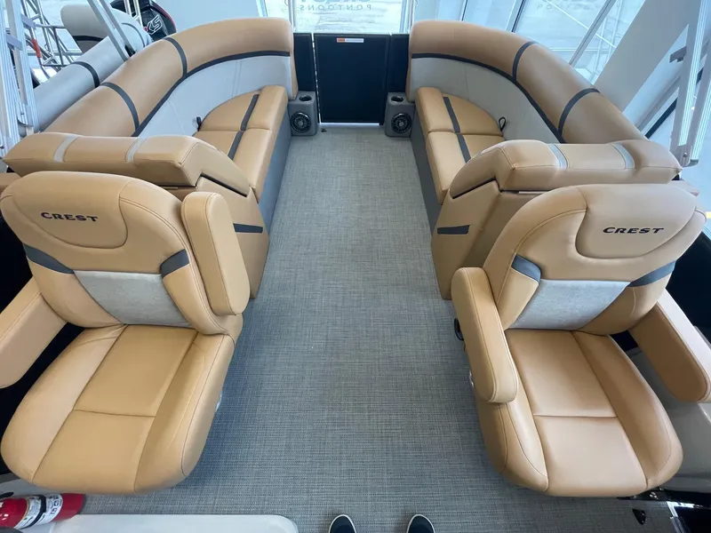 Slide: The Image of 2024 Crest 220SLC Classic LX boat interior with tan and gray seating. - 11