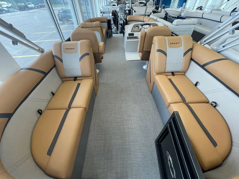 Slide: The Image of 2024 Crest 220SLC Classic LX boat interior with tan and gray seating. - 14