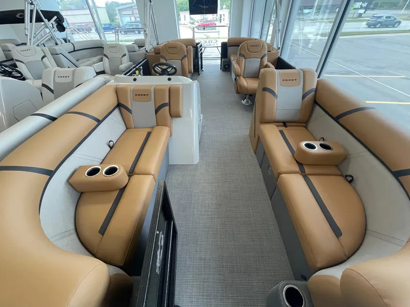 Slide: The Image of 2024 Crest 220SLC Classic LX pontoon boat interior with tan and gray seating. - 10