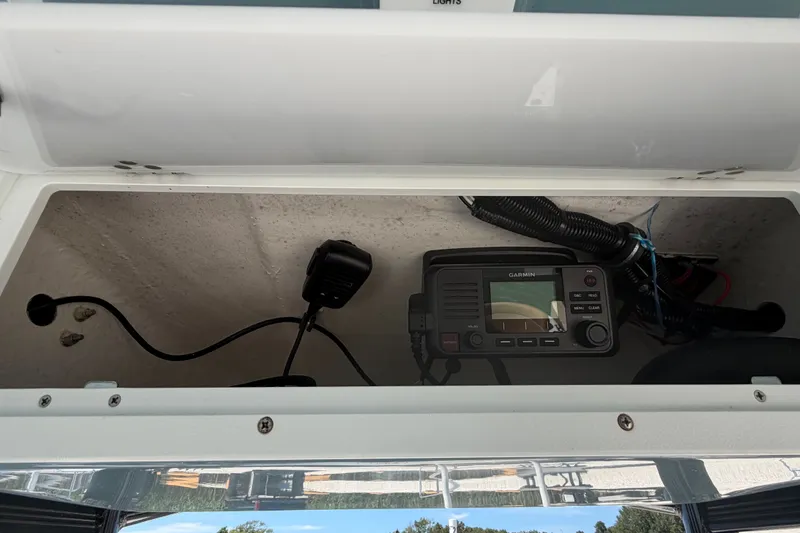 Slide: The Image of 2023 Sea Hunt Ultra 234 boat console with Garmin marine radio equipment. - 13