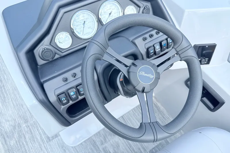 Slide: The Image of Steering wheel and dashboard of 2027 Bentley Pontoons Legacy 200 Navigator. - 14