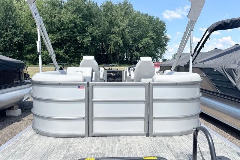 Slide: The Image of 2027 Bentley Pontoons Legacy 200 Navigator, sleek design, docked with lush greenery background. - 3