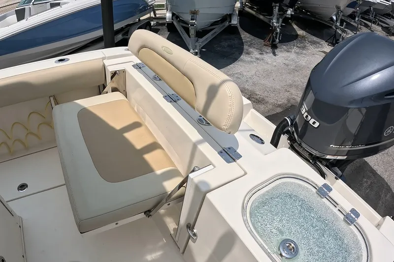 Slide: The Image of 2015 Cobia 237 Center Console boat with Yamaha 300 engine and beige seating. - 16