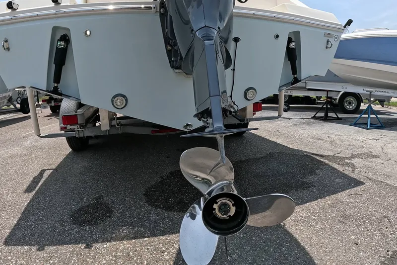 Slide: The Image of 2015 Cobia 237 Center Console boat on trailer, rear view with propeller. - 20