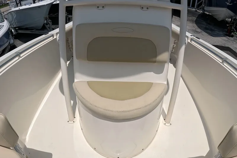 Slide: The Image of 2015 Cobia 237 Center Console boat seating area with beige cushions. - 15