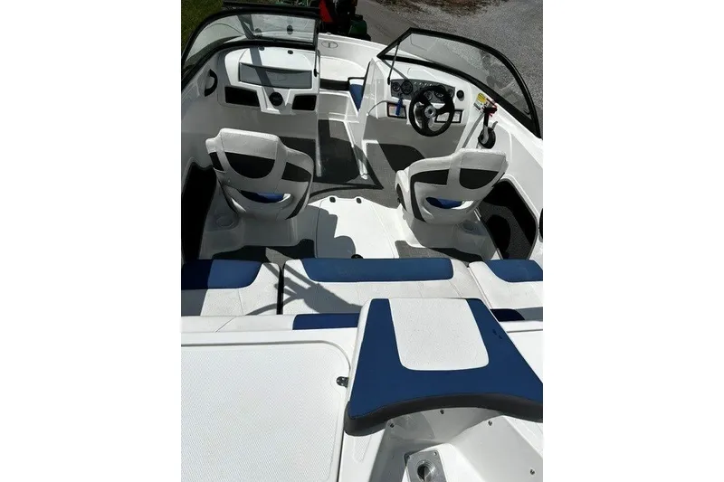 Slide: The Image of Interior of a 2021 Tahoe 450 TS boat with white and blue seating. - 11