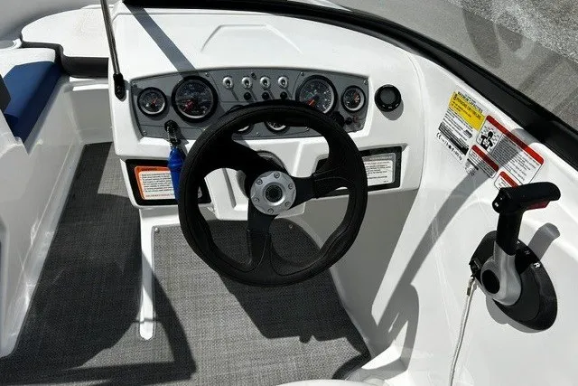 Slide: The Image of Cockpit of 2021 Tahoe 450 TS boat with steering wheel and control panel. - 13