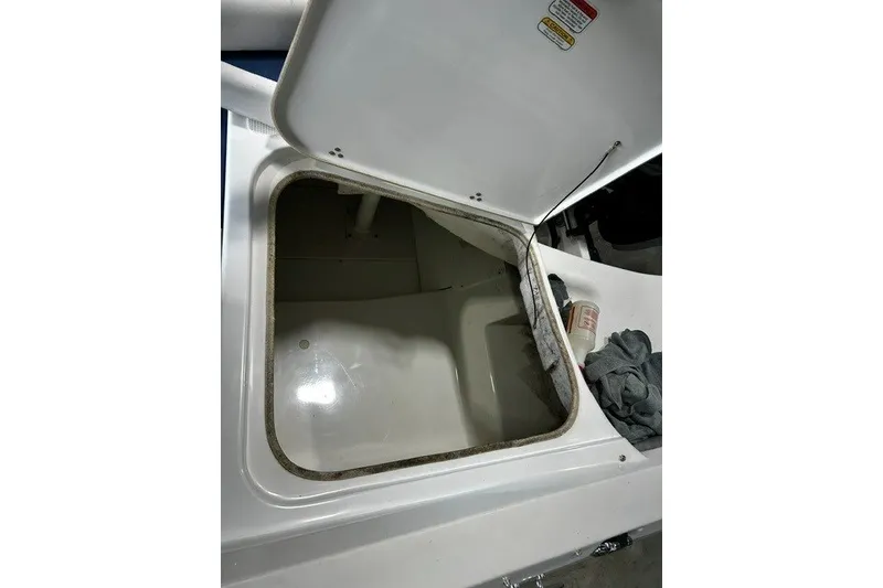 Slide: The Image of Open storage compartment on a 2021 Tahoe 450 TS boat, showing interior space. - 14