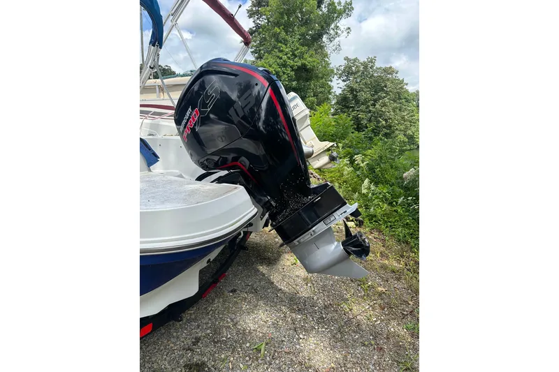 Slide: The Image of Outboard motor on a 2021 Tahoe 450 TS boat, parked on gravel. - 3