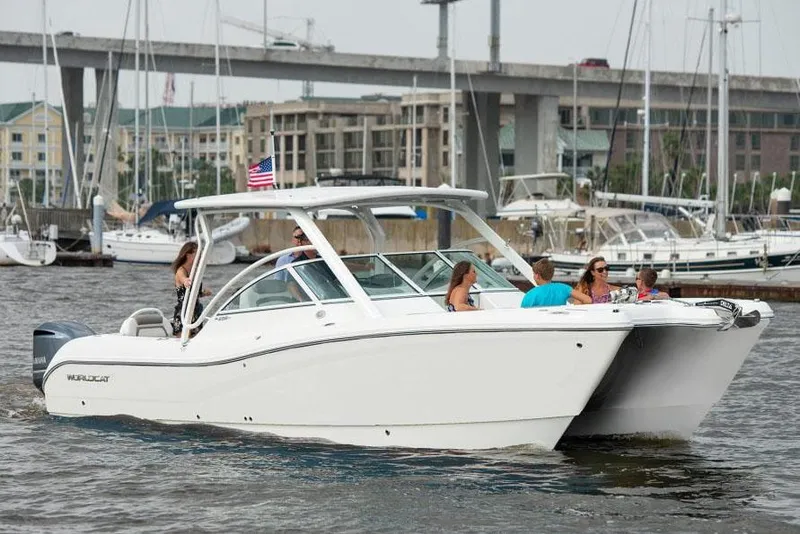 Slide: The Image of Manufacturer Provided Image: 2026 World Cat 296 DC boat cruising with passengers in a marina setting. - 5