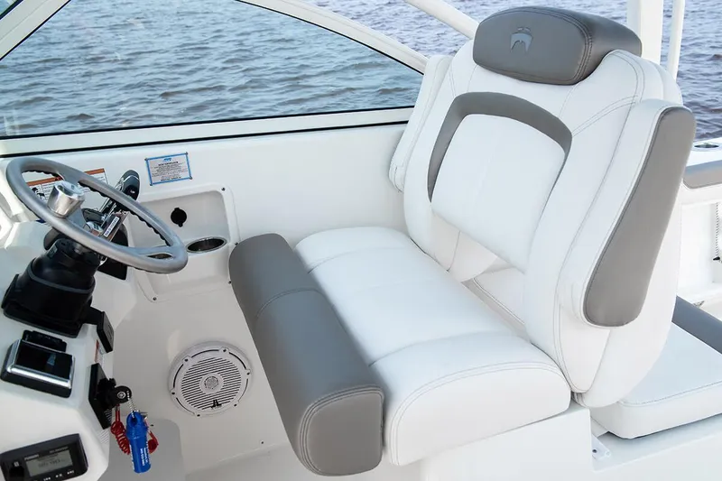 Slide: The Image of Manufacturer Provided Image: 2026 World Cat 296 DC boat interior with white and gray seating, steering wheel, and controls. - 13