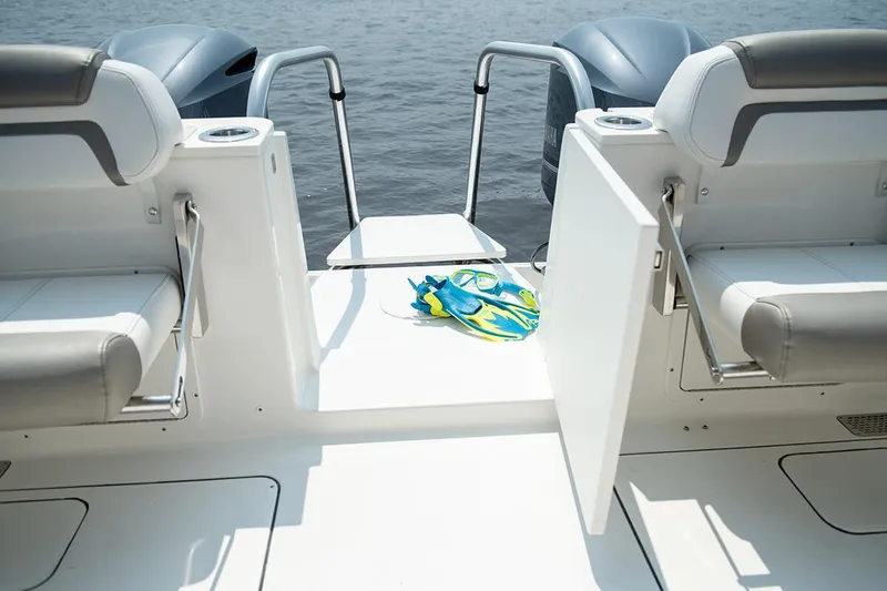 Slide: The Image of Manufacturer Provided Image: 2026 World Cat 296 DC boat interior with open door, flippers, and water view. - 19