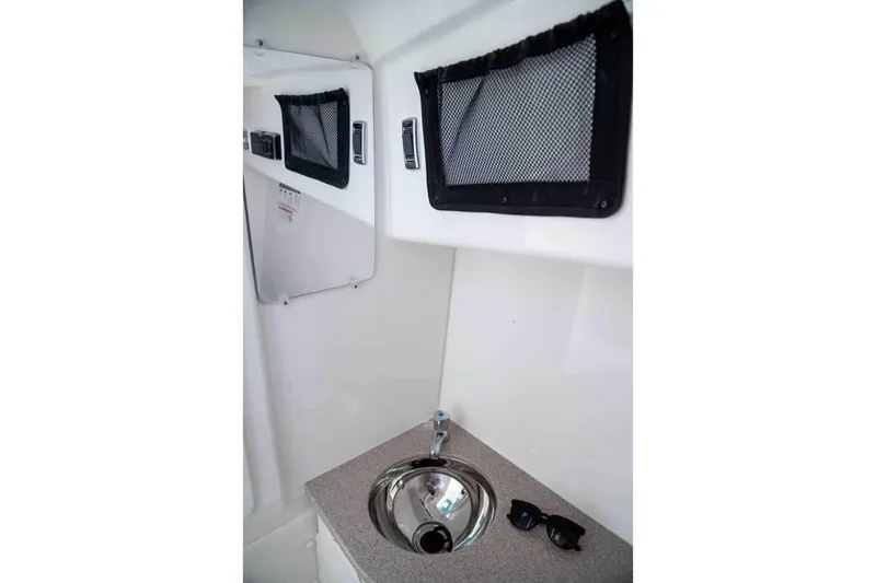 Slide: The Image of Manufacturer Provided Image: Interior of 2026 World Cat 296 DC boat featuring a compact sink and storage compartments. - 23