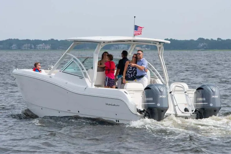 Slide: The Image of Manufacturer Provided Image: 2026 World Cat 296 DC boat cruising with passengers on a lake. - 7