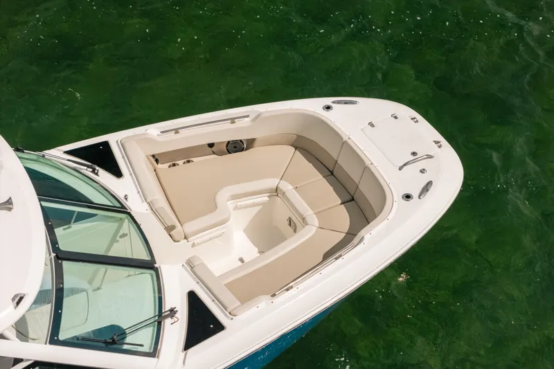 Slide: The Image of 2024 Boston Whaler 320 Vantage boat with spacious seating on green water. - 8