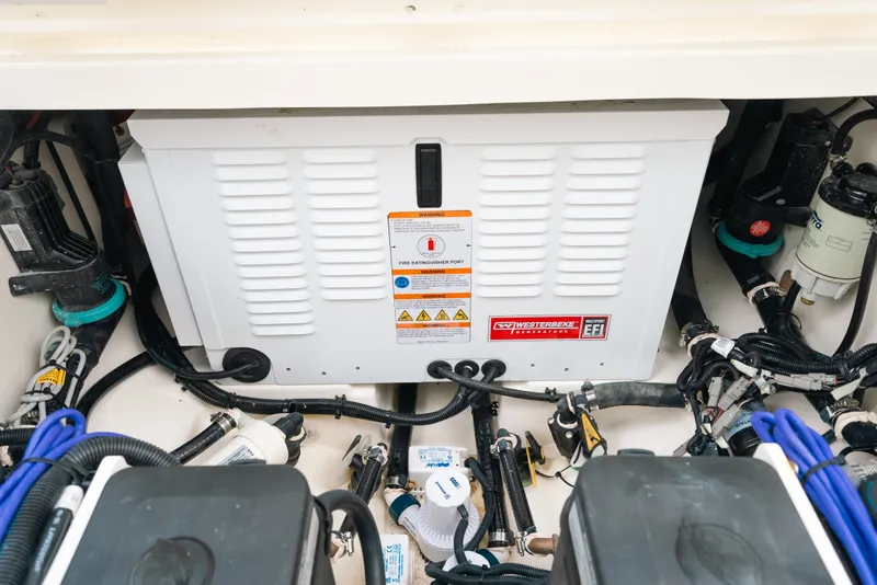 Slide: The Image of Engine compartment of 2024 Boston Whaler 320 Vantage, featuring Westerbeke generator and wiring. - 52